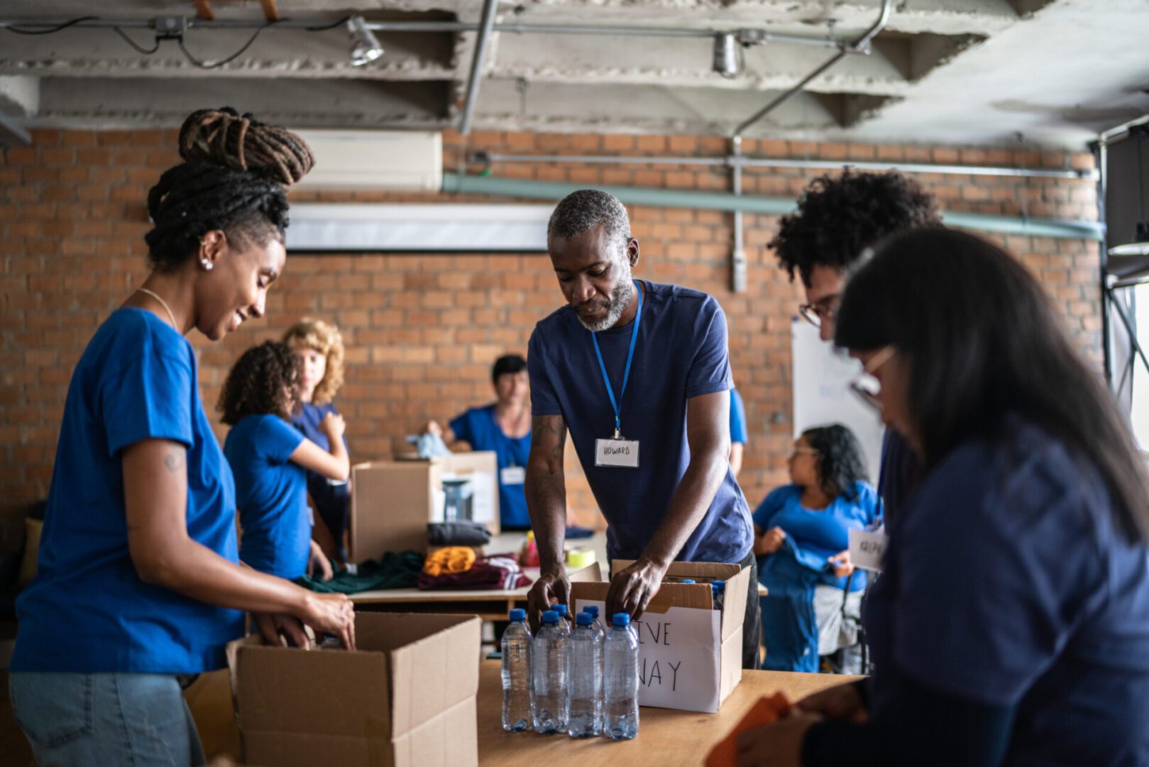 Volunteers packing supplies in a community center.
