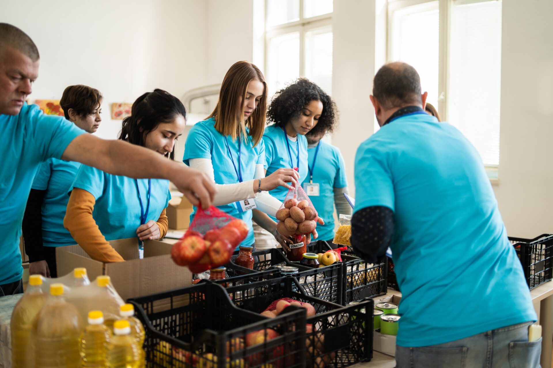 Volunteers sorting food at donation center.